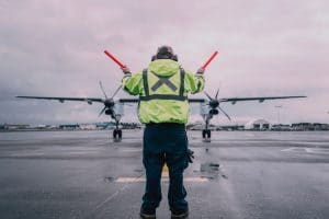 Air traffic controller directs a plane on the runway.