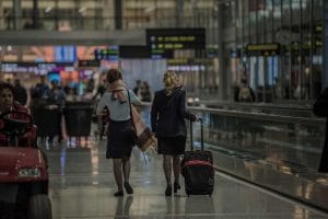 Flight attendants walk through airport.