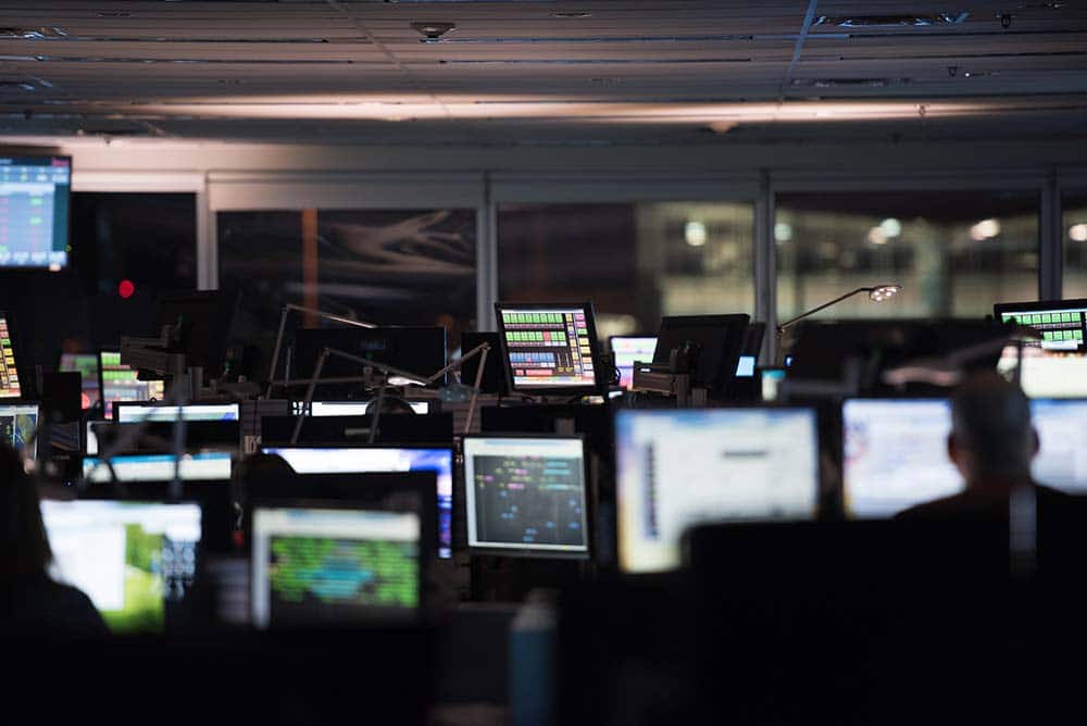 Office full of bright computer screens.