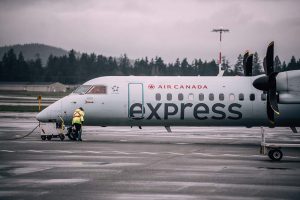 Ground service next to Air Canada express plane.