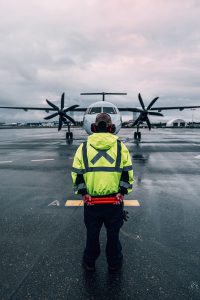 Ground service in front of prop plane.